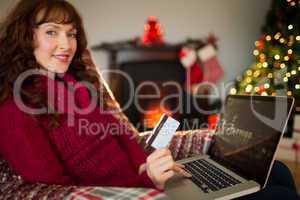 Smiling red hair shopping online with laptop