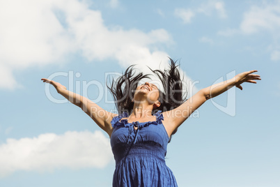 Pretty brunette in blue dress feeling free