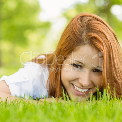 Portrait of a pretty redhead smiling and lying