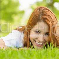 Portrait of a pretty redhead smiling and lying
