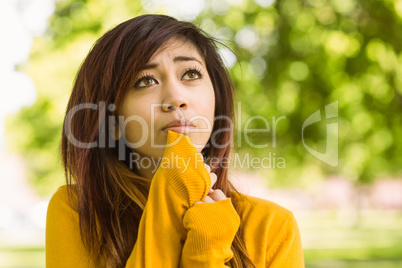 Beautiful young woman looking away in park