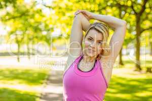 Fit blonde stretching in the park