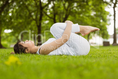 Side view of woman doing stretching exercises in park