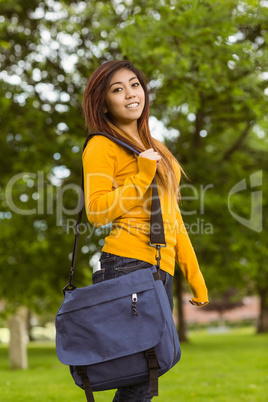 Female college student with bag in park