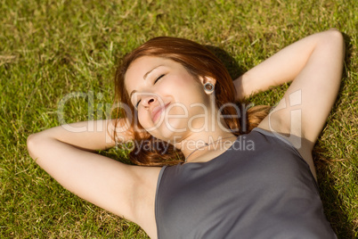 Pretty redhead lying with her eyes closed