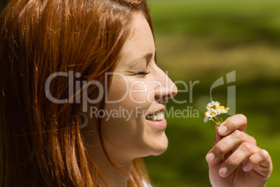 Portrait of a pretty redhead holding flowers