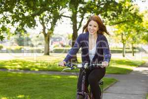 Pretty redhead cycling a bike