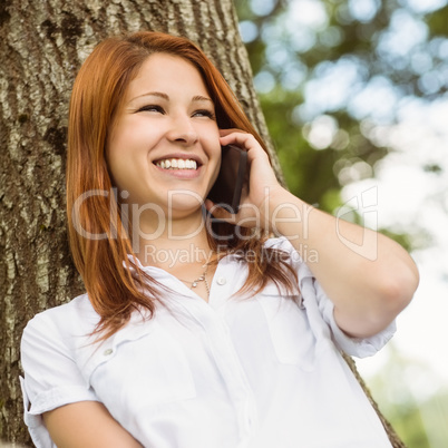 Pretty redhead smiling on the phone