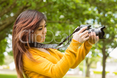 Beautiful female photographer at park