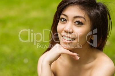 Beautiful woman with hand on chin in park