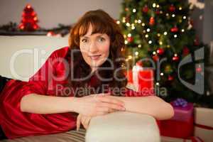 Beautiful redhead lying on the couch at christmas