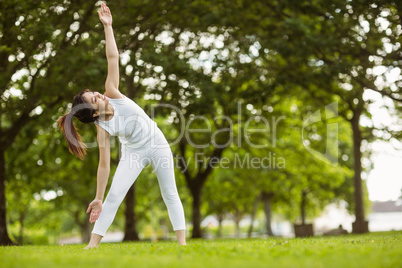 Toned woman doing stretching exercises in park