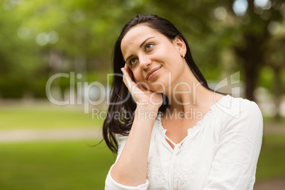 Smiling brunette standing and thinking