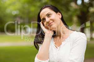 Smiling brunette standing and thinking