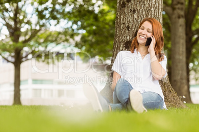 Pretty redhead smiling on the phone