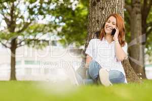 Pretty redhead smiling on the phone