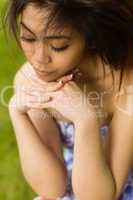 Thoughtful young woman in park