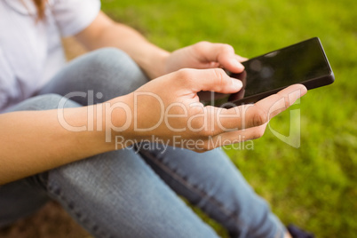Mid section of a pretty redhead texting Mid section of a pretty redhead texting