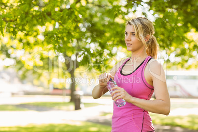 Fit blonde opening her water bottle