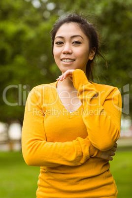 Beautiful woman with hand on chin in park