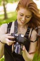 Beautiful female photographer at park