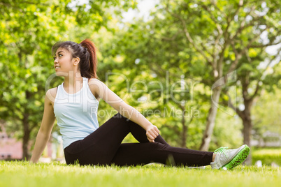 Healthy woman doing stretching exercises in park
