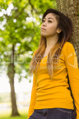 Beautiful woman standing against tree