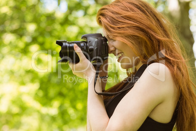 Beautiful female photographer at park