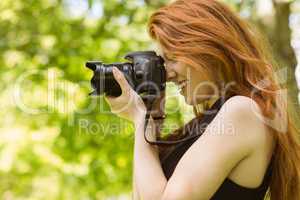 Beautiful female photographer at park