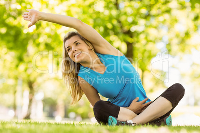 Fit blonde stretching in the park