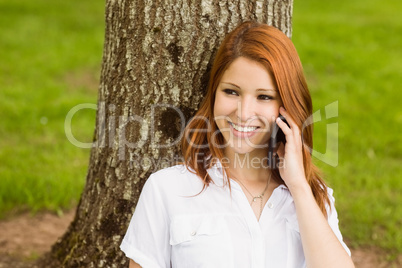 Pretty redhead smiling on the phone