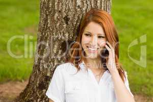 Pretty redhead smiling on the phone