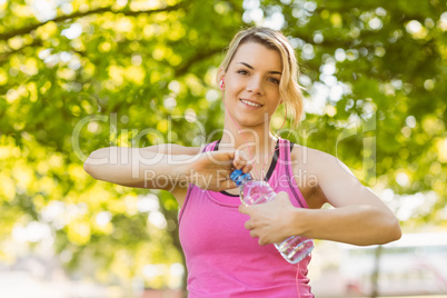 Fit blonde opening her water bottle