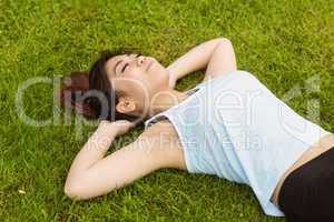 Healthy woman lying on grass in park