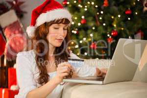 Redhead shopping online with laptop at christmas