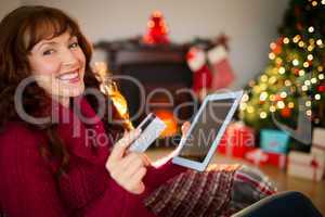 Happy redhead shopping online with tablet