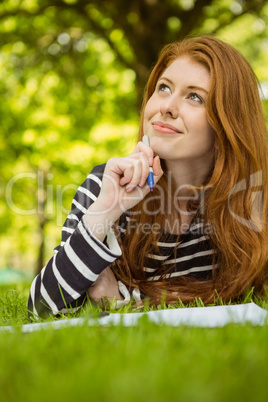 Female student doing homework in park