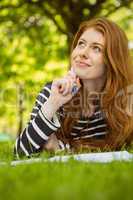 Female student doing homework in park