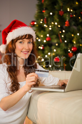 Redhead shopping online with laptop at christmas