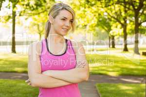 Fit blonde smiling in the park