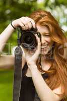 Beautiful female photographer at park