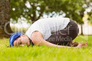 Brunette relaxing and meditating on grass