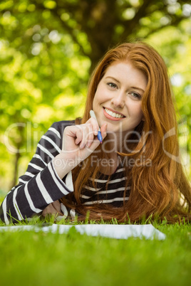 Female student doing homework in park