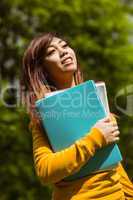 Female college student with books in park