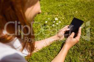 Pretty redhead text messaging on her phone