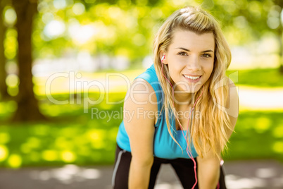 Fit blonde smiling in the park