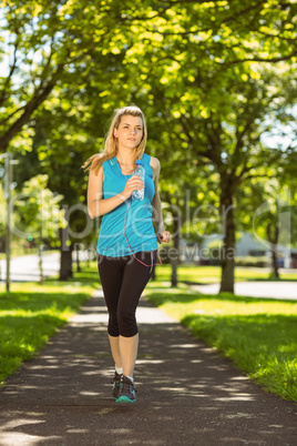 Fit blonde jogging in the park