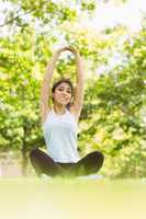 Healthy woman stretching hands in park