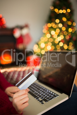 Woman shopping online with laptop at christmas