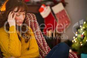 Unhappy redhead getting a headache at christmas